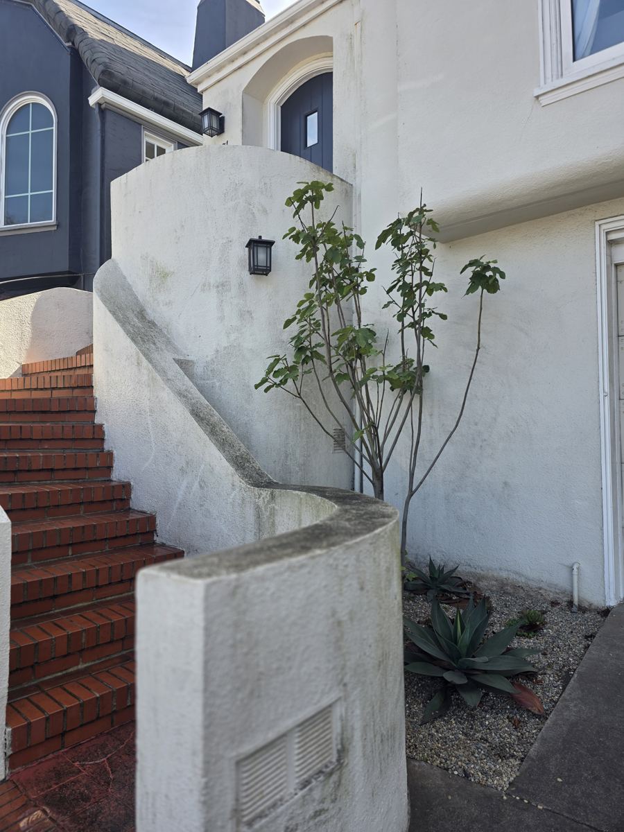 Stucco wall and steps before power washing